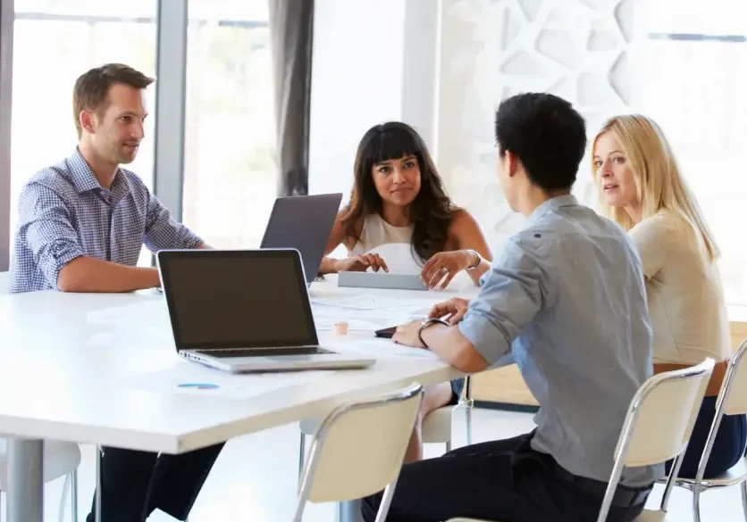 A group of people sitting around a table.